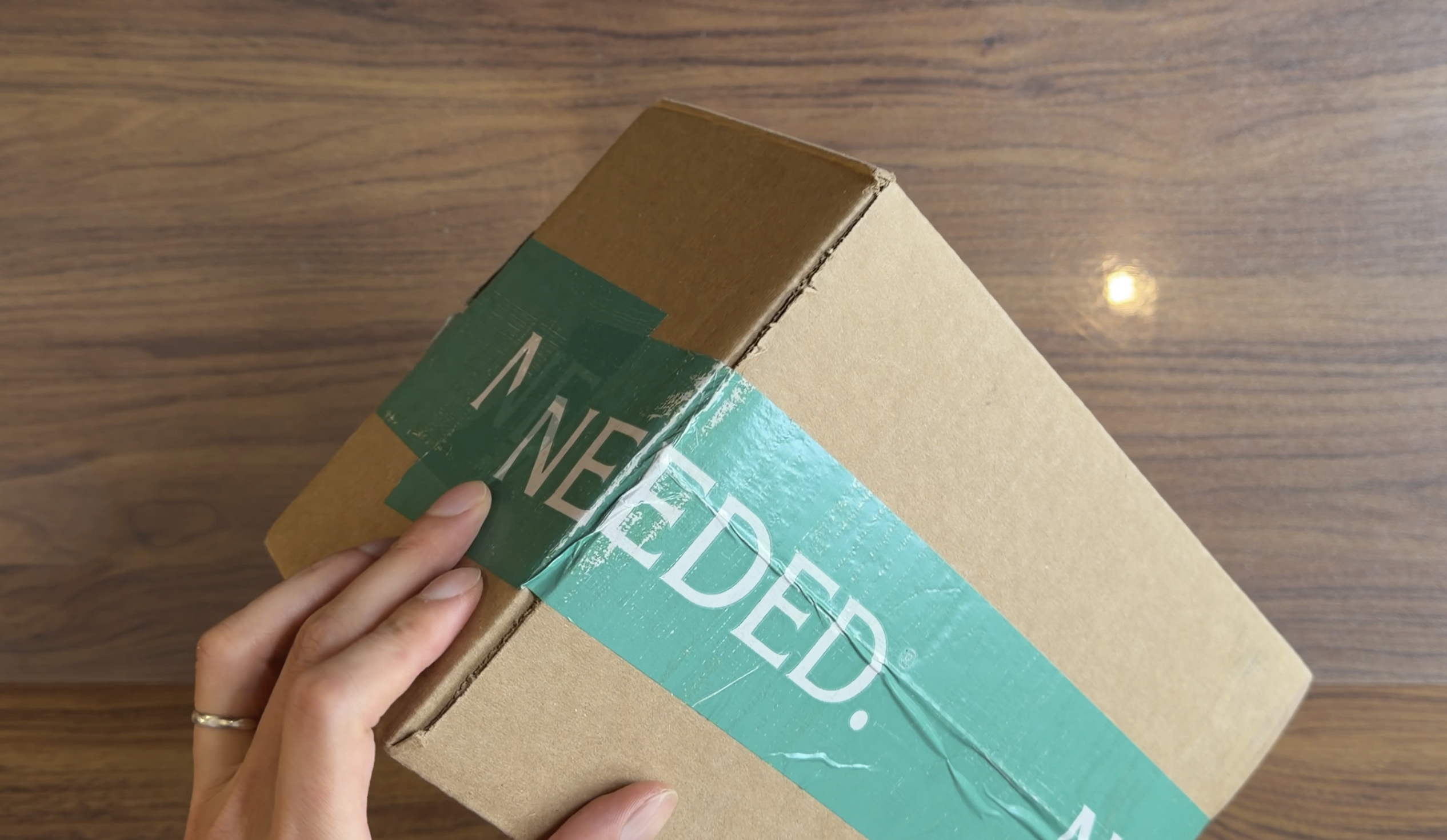 Worn green Needed tape across the shipping carton seam